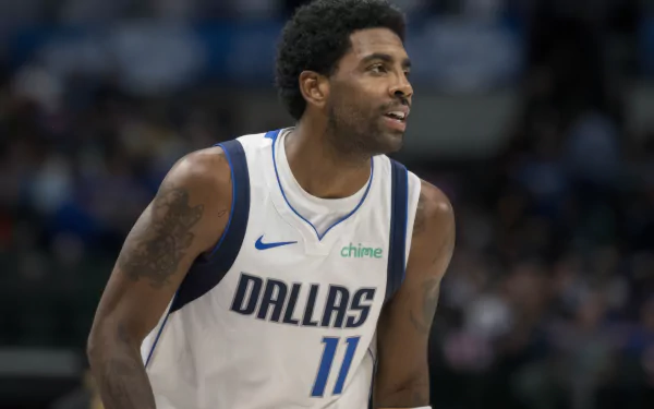 HD wallpaper featuring a basketball player in a Dallas Mavericks jersey, number 11, on the court during a game.