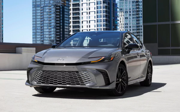 A Toyota Camry XSE parked with modern high-rise buildings in the background, used as an HD desktop wallpaper.