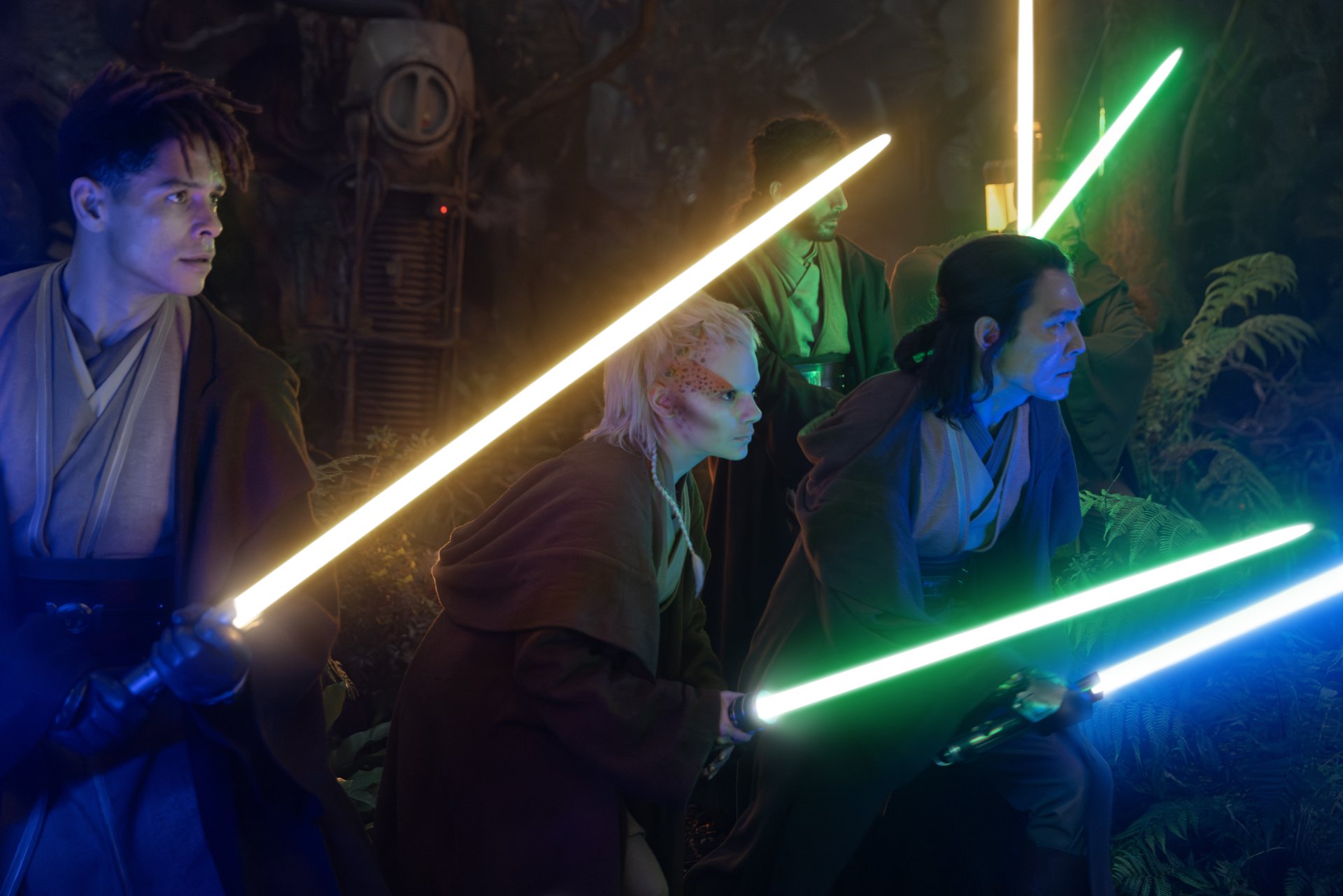 HD desktop wallpaper from the TV show The Acolyte (2024), featuring Jedi wielding colorful lightsabers in a forest setting.
