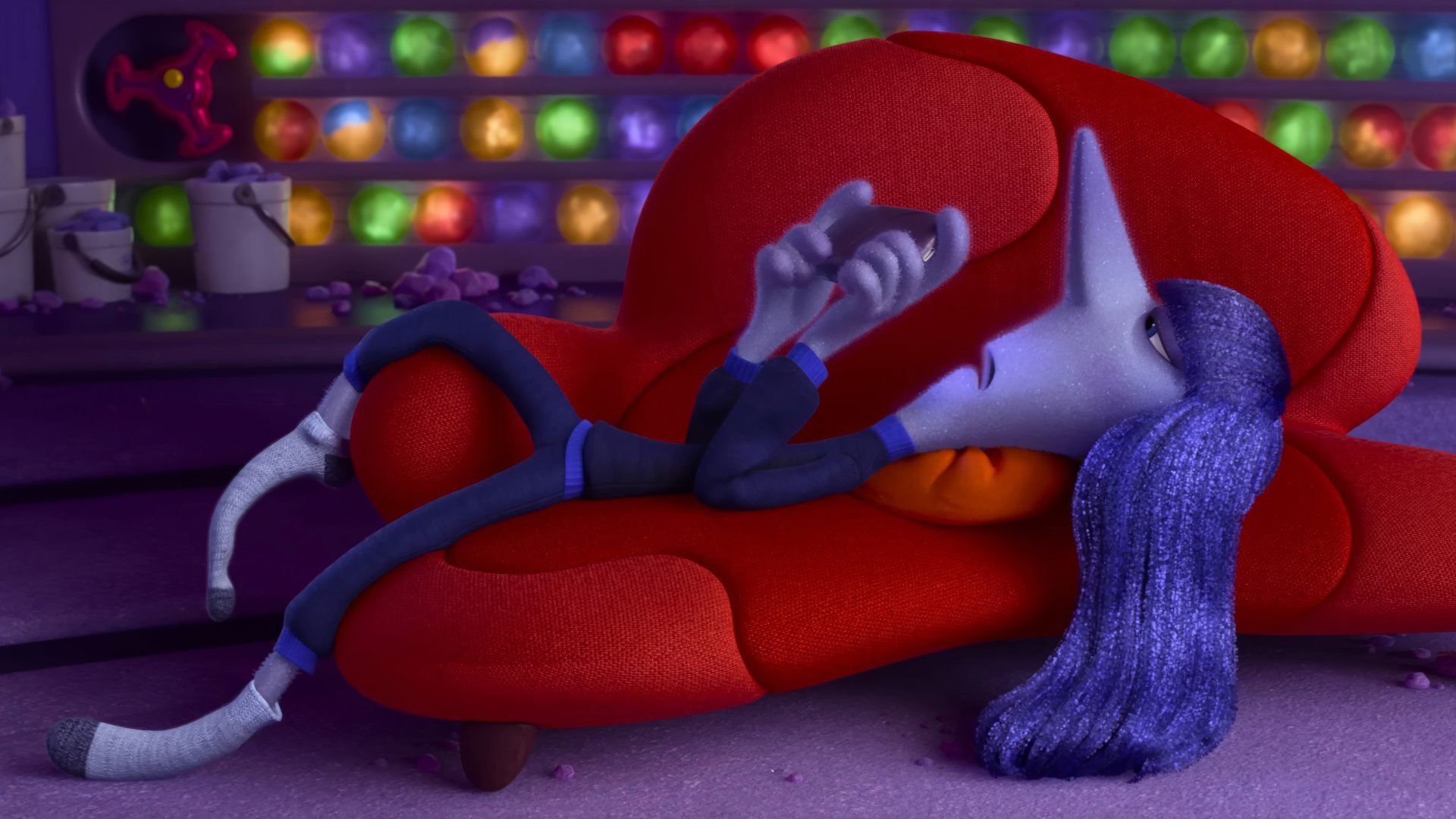 HD desktop wallpaper featuring Ennui from Inside Out 2, lounging on a red sofa with colorful lights in the background.