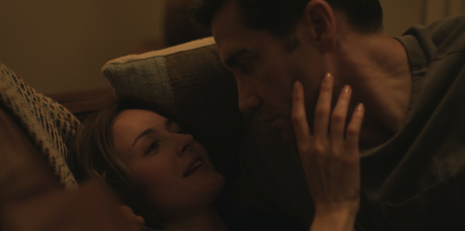 A still from the TV show Presumed Innocent (2024), featuring an intimate moment between two characters, set against a warm-toned background, captured as an HD desktop wallpaper.