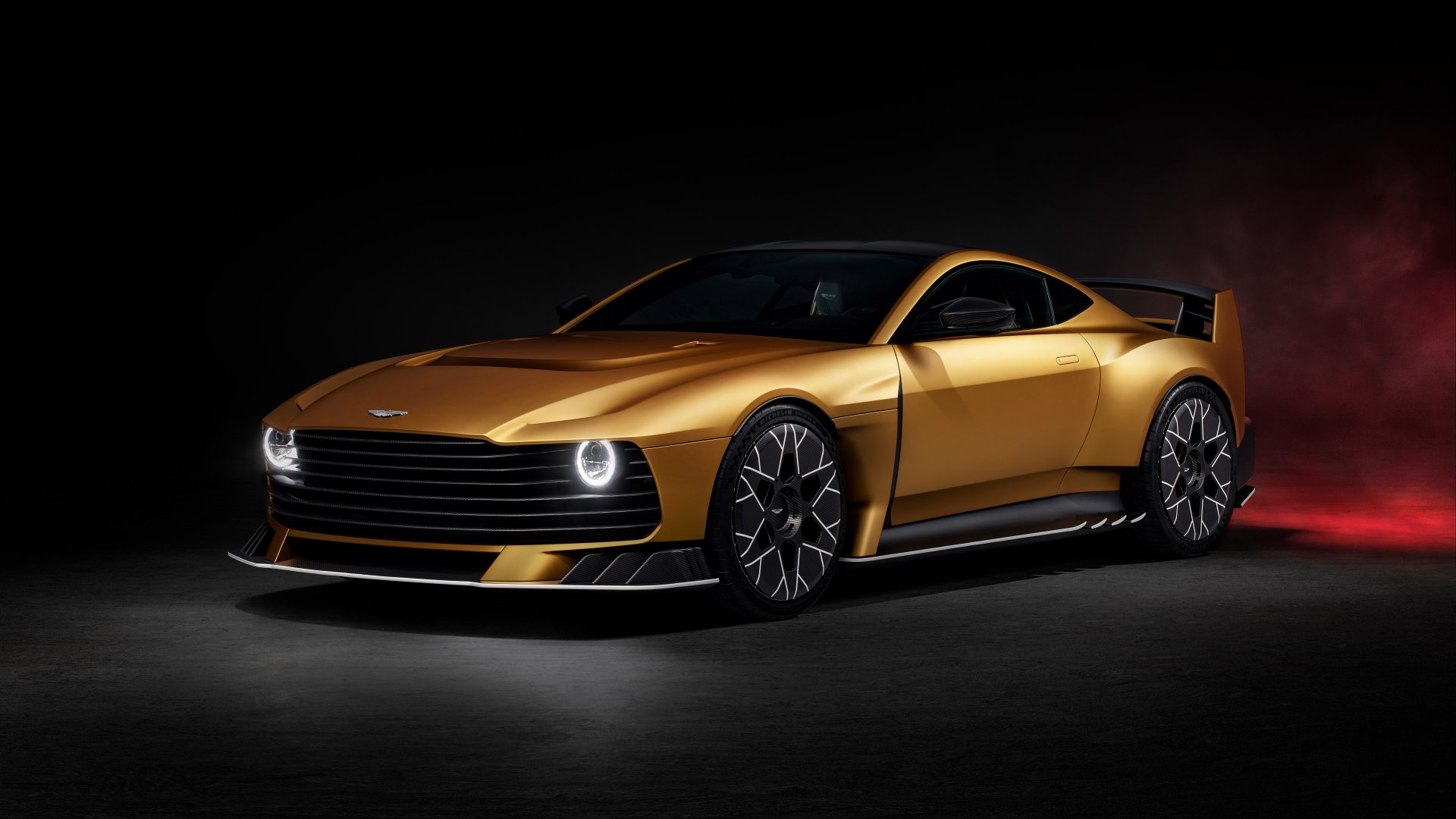 HD desktop wallpaper featuring a sleek, gold Aston Martin Valiant car against a dark background, showcasing its detailed design and powerful appearance.