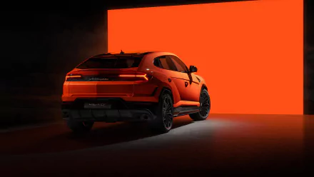 HD desktop wallpaper of an orange Lamborghini Urus against a vibrant red background, highlighting the vehicle’s sleek design and sporty appeal.