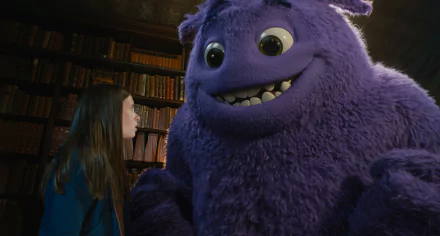 A scene from the movie IF (2024) featuring Cailey Fleming with a large purple furry creature, set in an environment filled with books. This HD desktop wallpaper showcases the enchanting interaction.