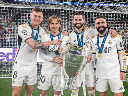 Real Madrid C.F. players celebrate with the UEFA Champions League trophy. This HD desktop wallpaper captures the victorious moment in high definition.