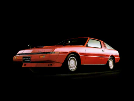 HD desktop wallpaper featuring a classic red Mitsubishi Starion Turbo vehicle, displayed against a dark background.