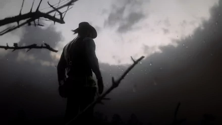 A silhouette of Arthur Morgan from Red Dead Redemption 2 stands against a moody, cloudy sky in this striking 4K Ultra HD PC desktop wallpaper.