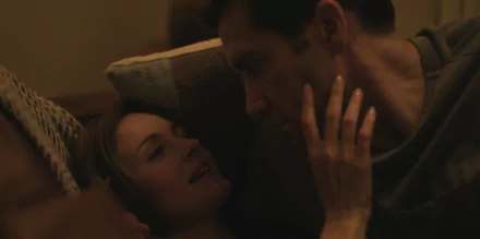 A still from the TV show Presumed Innocent (2024), featuring an intimate moment between two characters, set against a warm-toned background, captured as an HD desktop wallpaper.