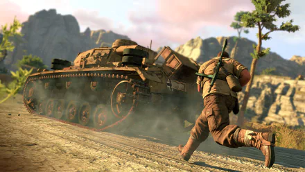 HD desktop wallpaper from Sniper Elite III video game featuring a soldier running next to a tank in a rugged, mountainous environment with clear skies.