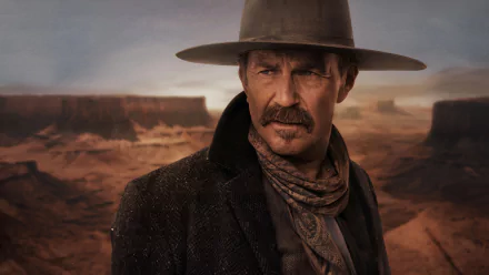 HD desktop wallpaper of Kevin Costner in Horizon: An American Saga - Chapter 1, featuring him in a Western landscape with rugged terrain and sunset hues.