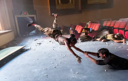 HD desktop wallpaper and background featuring a dramatic scene from the movie Twisters, showing intense wind force inside a theater with characters being swept away.