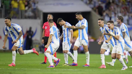 The Argentina National Football Team celebrates on the field. This HD desktop wallpaper features players in action, including Julián Álvarez, against a vibrant soccer stadium backdrop.