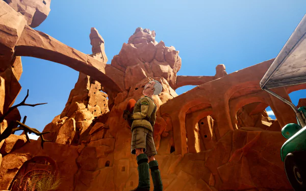 HD desktop wallpaper of Sand Land from a video game, featuring a character standing in a rocky, desert environment under a bright blue sky.