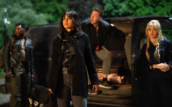 HD desktop wallpaper from the movie Abigail (2024) featuring a tense scene with four characters standing beside a vehicle at night.