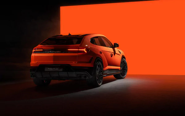 HD desktop wallpaper of an orange Lamborghini Urus against a vibrant red background, highlighting the vehicle’s sleek design and sporty appeal.