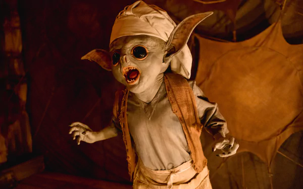 HD desktop wallpaper featuring a creature from the 2023 Doctor Who TV show, set in a moody, dimly-lit environment.