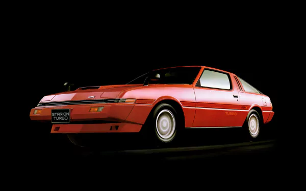 HD desktop wallpaper featuring a classic red Mitsubishi Starion Turbo vehicle, displayed against a dark background.