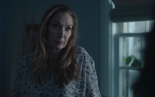 HD desktop wallpaper from the TV show Presumed Innocent (2024), featuring a scene with a woman in a dimly lit room near a window.
