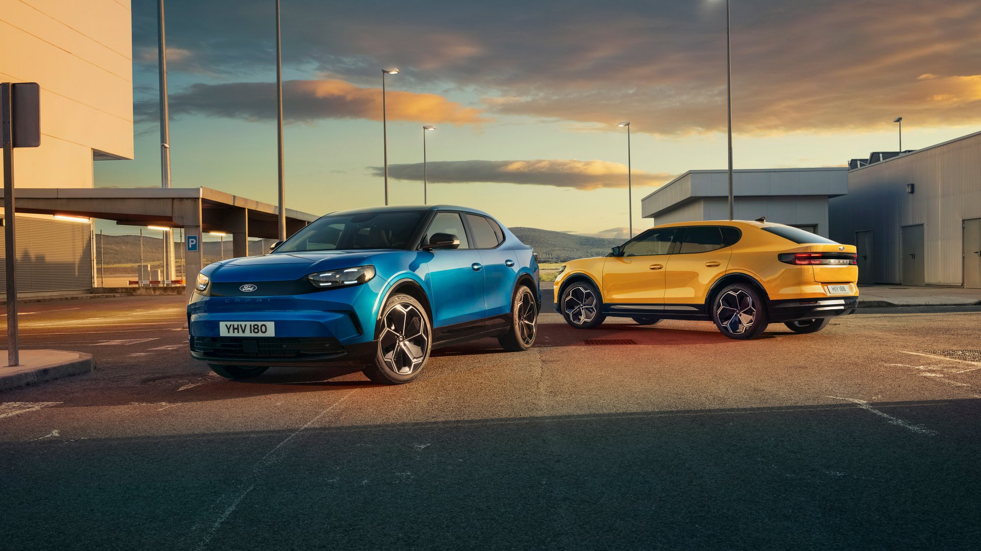 A vibrant HD desktop wallpaper featuring a blue and a yellow Ford Capri parked under a sunset sky, showcasing the stylish design of these iconic cars.