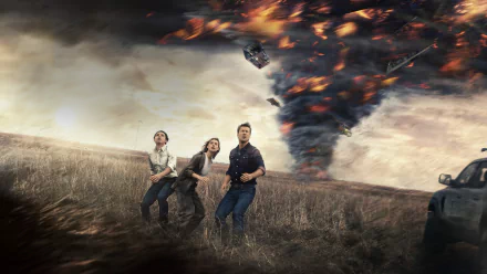4K Ultra HD PC desktop wallpaper showing three people running from a massive fiery twister sweeping across a barren field under a stormy sky.