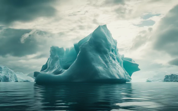 A majestic iceberg rises dramatically from calm waters under a moody sky, creating a stunning HD desktop wallpaper and background.