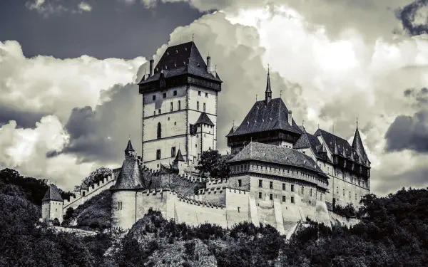 A breathtaking view of Karlštejn Castle in the Czech Republic, showcasing stunning gothic architecture. This HD image serves as an impressive desktop wallpaper and background.
