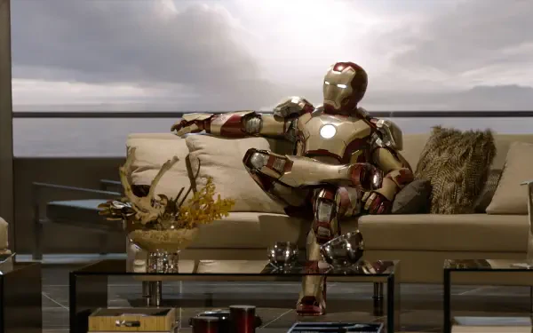 A high-definition desktop wallpaper featuring Iron Man lounging on a stylish sofa, with a dramatic sky in the background, capturing the essence of the superhero movie.