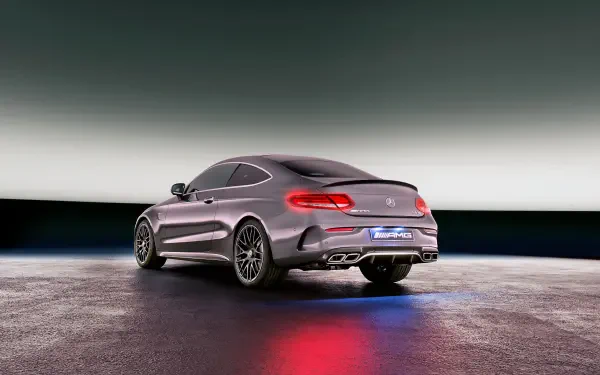 HD PC desktop wallpaper featuring a sleek silver Mercedes-Benz AMG C63 showcased in a modern, minimalist setting with reflective flooring and subtle lighting.