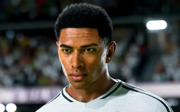 A high-definition desktop wallpaper featuring Jude Bellingham, a prominent player in EA SPORTS FC 25, capturing his focused expression during a soccer match.