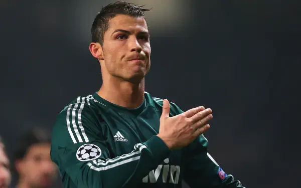 Cristiano Ronaldo, in a Real Madrid C.F. jersey, gestures during a match, captured in stunning 4K Ultra HD, showcasing his intensity and passion for soccer.