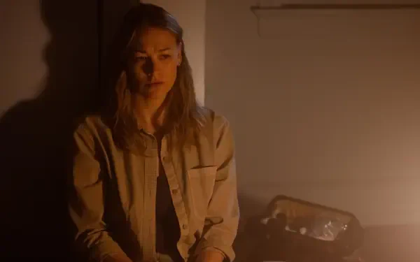 A dramatic scene from the TV show Teacup (2024), featuring Yvonne Strahovski in a dimly lit room, conveying deep emotion and tension. 4K Ultra HD wallpaper for desktop.