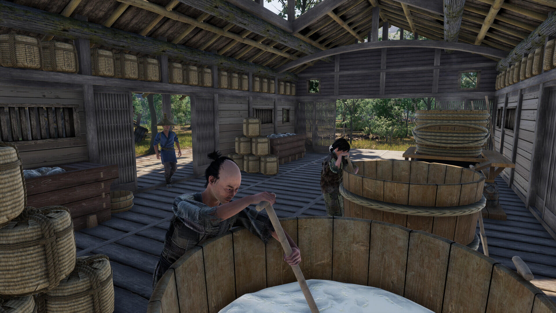 A scene from the video game Sengoku Dynasty features characters working in a wooden building, engaged in traditional activities against a backdrop of nature. HD PC desktop wallpaper.