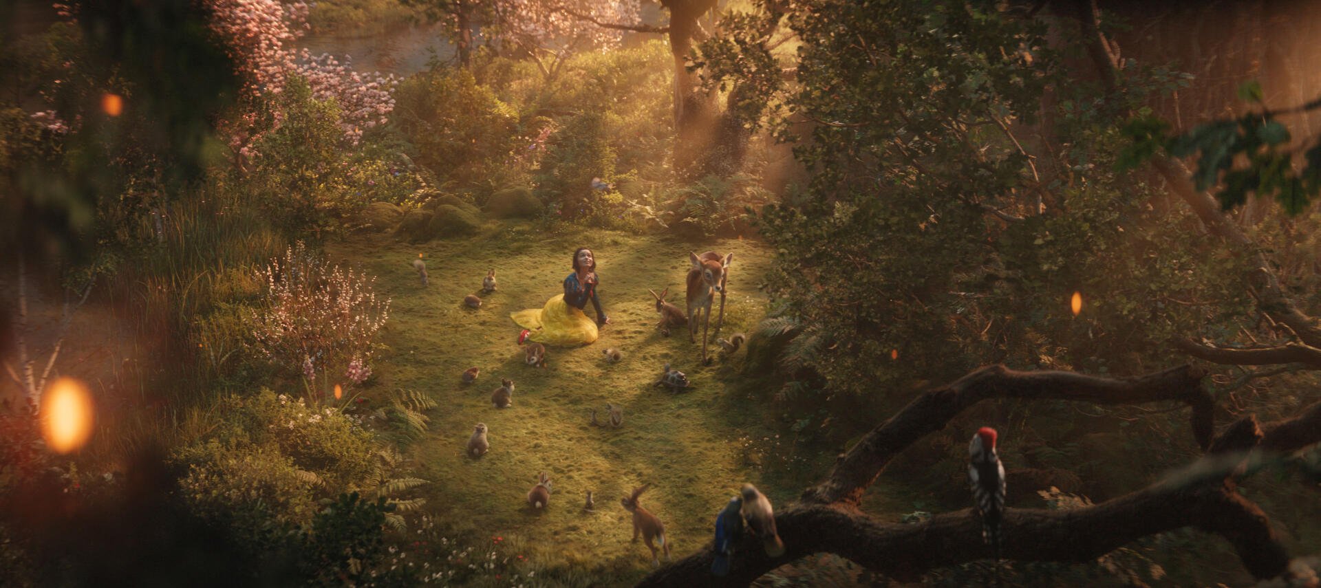 A vibrant scene from the 2025 movie Snow White, featuring the character in a yellow dress surrounded by animals in a sunlit forest filled with lush greenery and colorful flowers.