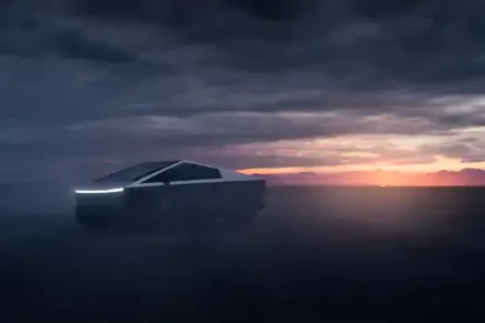 A Tesla Cybertruck is shown in a dramatic landscape, shrouded in mist with a striking sunset in the background, highlighting its futuristic design in this 4K Ultra HD wallpaper.