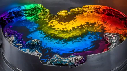 A vibrant color spectrum displayed in a reflective liquid surface, capturing a dazzling array of hues, designed as a 4K Ultra HD PC desktop wallpaper and background.