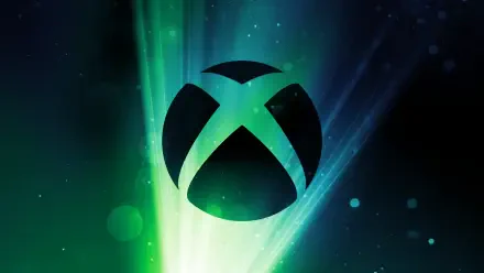 A vibrant HD PC desktop wallpaper featuring the Xbox logo against a backdrop of green and blue light rays, capturing the essence of video gaming.