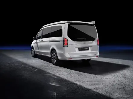 A sleek Mercedes-Benz V-Class Marco Polo in a striking white finish, showcased against a dark background, emphasizing its modern design and elegance. 4K Ultra HD quality enhances the visual appeal.