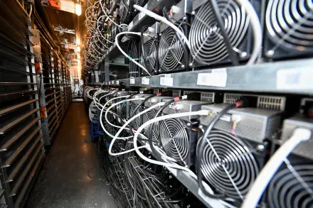 A detailed view of a crypto mining setup, showcasing rows of powerful cooling fans and intricate wiring in a high-tech environment, presented as a 4K Ultra HD desktop wallpaper.