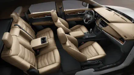 Interior view of a Cadillac XT5, showcasing luxurious beige seating and a modern dashboard, designed for comfort and style. High-definition image suitable as a desktop wallpaper.