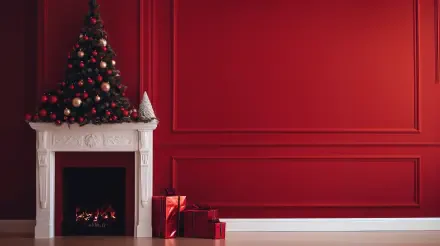A minimalist holiday scene featuring a beautifully decorated Christmas tree beside a white fireplace, set against vibrant red walls, captured in 4K Ultra HD for a stunning desktop wallpaper.