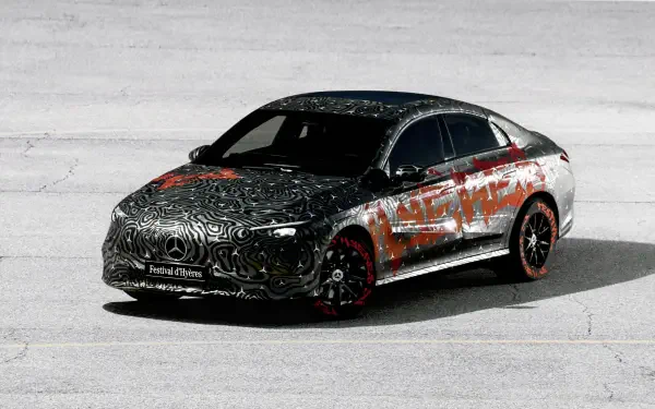 A high-definition desktop wallpaper featuring a stylish Mercedes-Benz CLA, stylishly camouflaged with intricate patterns and designs against a sleek, minimalist background.