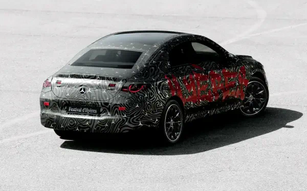 A sleek Mercedes-Benz CLA is showcased in a striking design, featuring a camouflage wrap. This high-definition image serves as a desktop wallpaper and background.