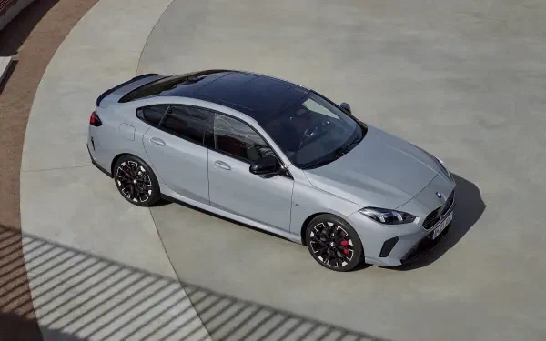 Silver BMW M235 Gran Coupe parked on a concrete surface, showcased in a HD PC desktop wallpaper with sharp details and sleek design.