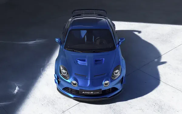 Blue Alpine A110 R Ultime sports car showcased in a high-resolution, 4K Ultra HD desktop wallpaper with sharp lighting and detailed shadows.
