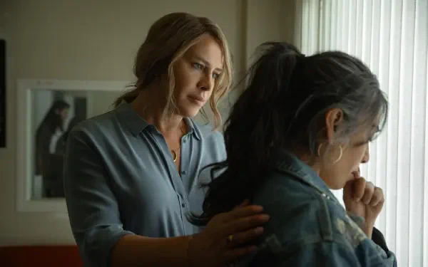 A still from the movie Emilia Pérez, featuring two women in a moment of emotional connection, set against a softly lit background. 4K Ultra HD desktop wallpaper.