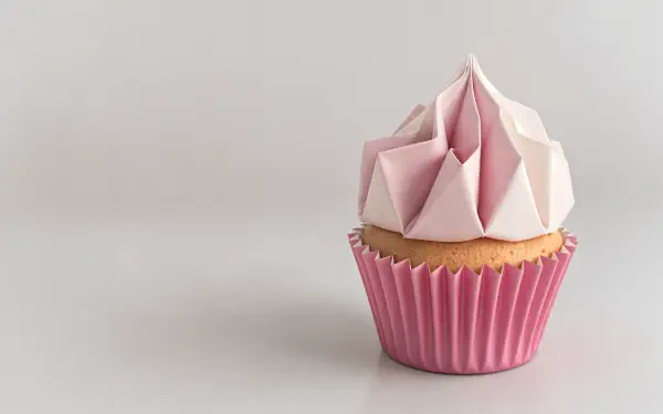 A beautifully designed cupcake with pink frosting sits in a pink wrapper against a clean background, showcased in vivid detail as a 4K Ultra HD desktop wallpaper.