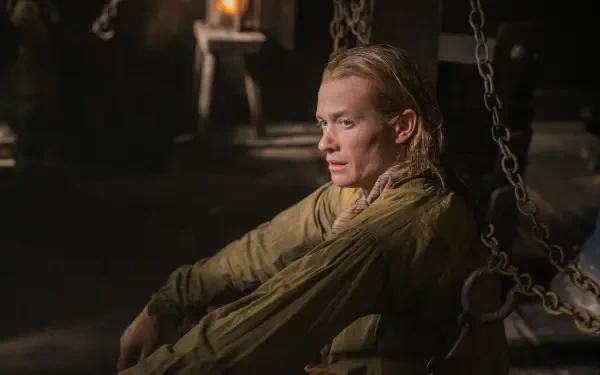 Ed Speleers portrays a contemplative character in this dramatic scene from the TV show Outlander, captured in stunning 4K Ultra HD detail and ambiance.