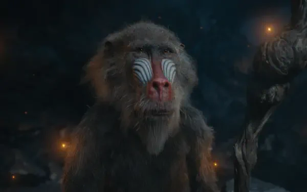 A close-up of a wise baboon from Mufasa: The Lion King, featuring intricate markings on its face, set against a mystical backdrop with glowing lights, designed as an HD PC desktop wallpaper.