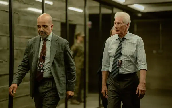 A scene from the TV show The Agency, featuring Richard Gere and Jeffrey Wright walking through a modern hallway, captured in stunning 8K Ultra HD.