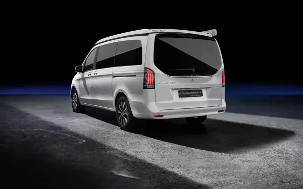 A sleek Mercedes-Benz V-Class Marco Polo in a striking white finish, showcased against a dark background, emphasizing its modern design and elegance. 4K Ultra HD quality enhances the visual appeal.